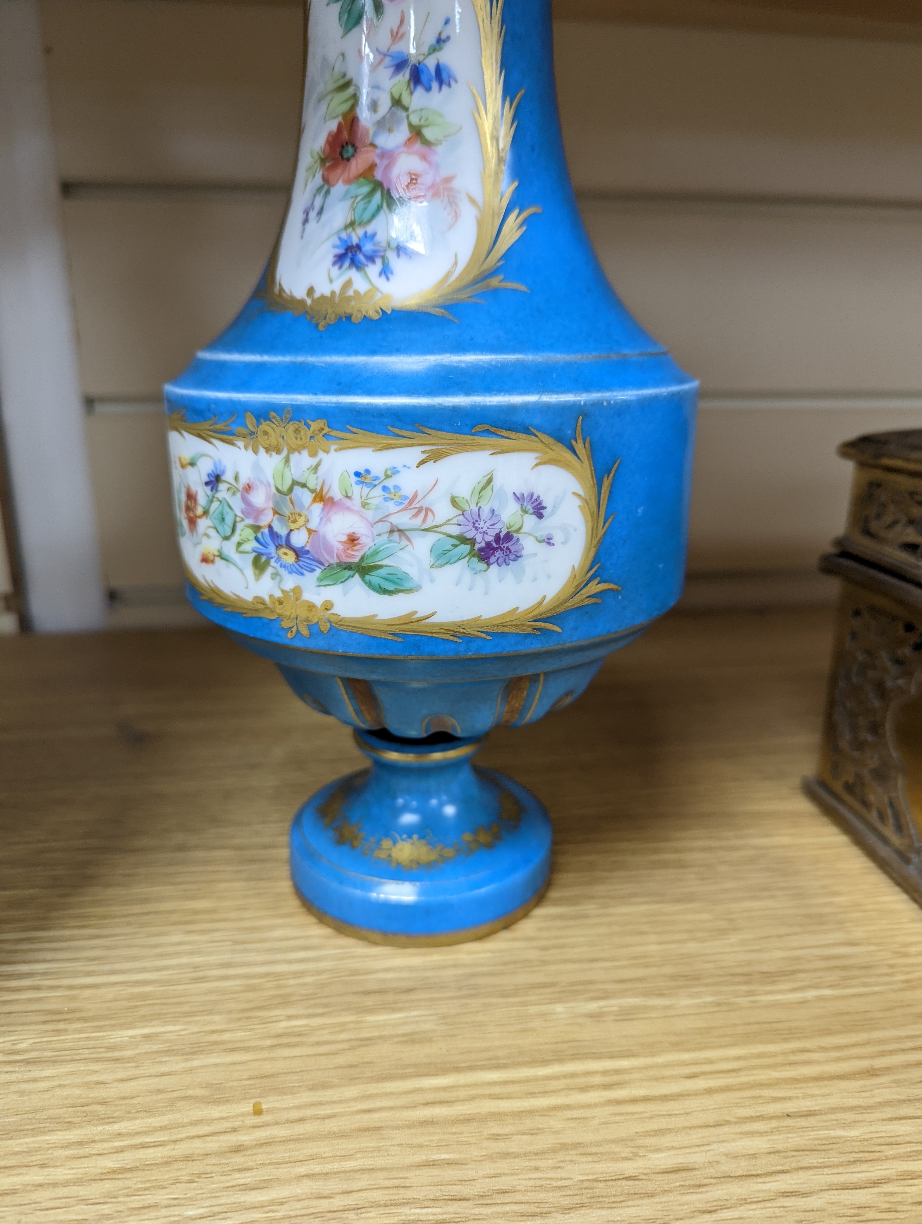 A pair of Sevres style porcelain bleu celeste ground vases and covers, 34cm